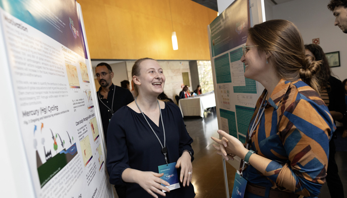 Photo of 2 students at a conference