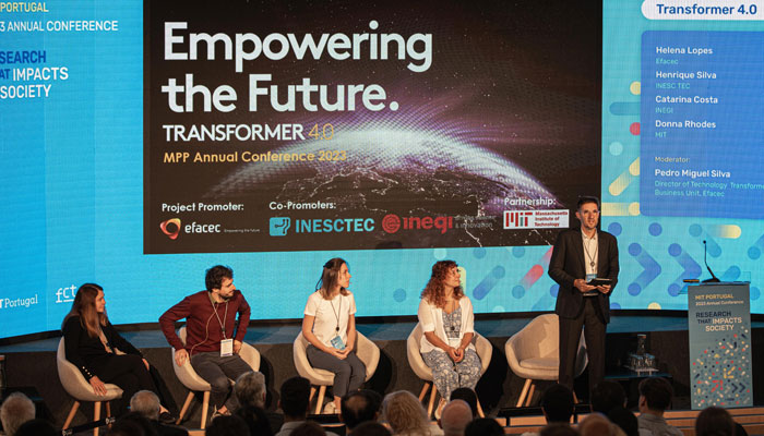 Photo of speakers on stage